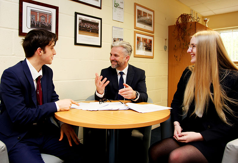 Head of Sixth Form talking to students