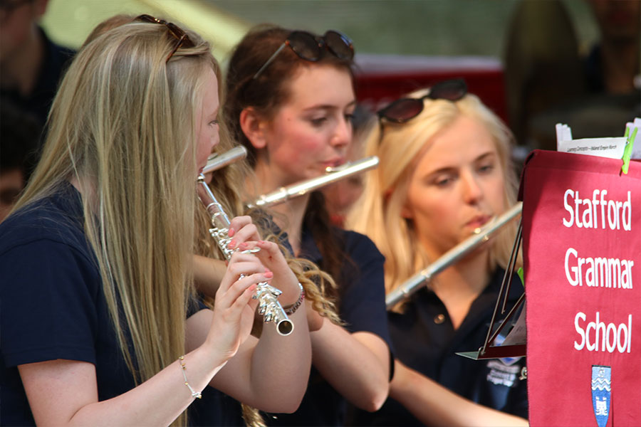 Music students playing instruments in the school orchestra