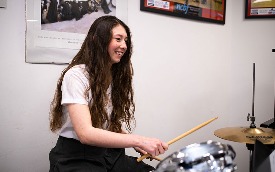 pupil playing the drums 
